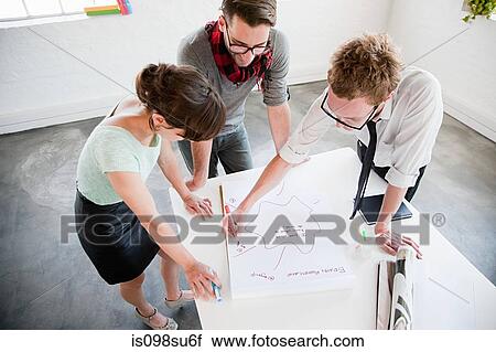 Stock Image - Fashion designers at work. Fotosearch
