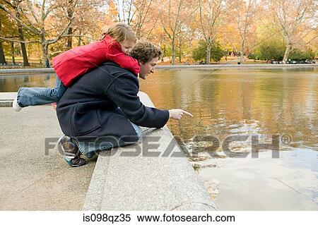 Father and daughter by pond View Large Photo Image Stock Photography - Father and daughter by pond. Fotosearch