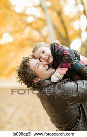 Stock Image - Father and daughter in park. Fotosearch