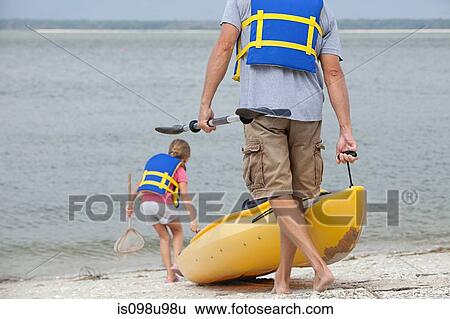 Stock Photograph - Father and daughter kayaking. Fotosearch