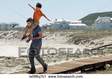 Stock Image - Father and son at the coast. Fotosearch