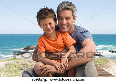 Stock Photography - Father and son by the sea. Fotosearch