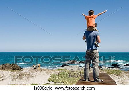 Father and son by the sea View Large Photo Image Stock Photography - Father and son by the sea. Fotosearch