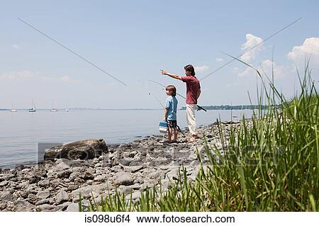 Father and son on beach with fishing rods View Large Photo Image Picture - Father and son on beach with fishing rods. Fotosearch