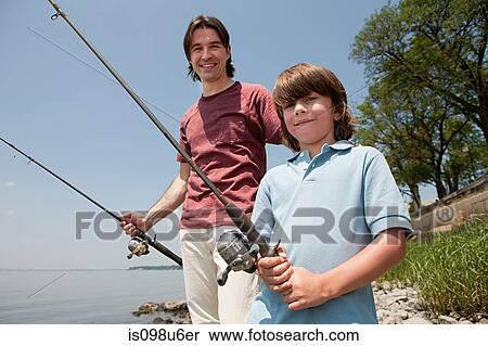 Father and son on beach with fishing rods View Large Photo Image Stock Photography - Father and son on beach with fishing rods. Fotosearch