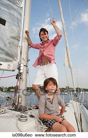 Picture - Father and son on board yacht, portrait. Fotosearch