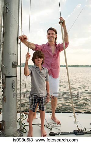 Stock Photo - Father and son on board yacht, portrait. Fotosearch