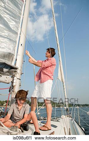Father and son on board yacht View Large Photo Image Stock Image - Father and son on board yacht. Fotosearch
