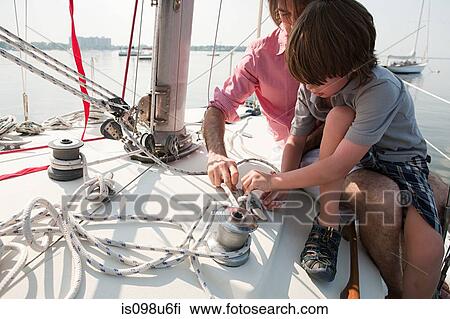 Father and son on board yacht with rope View Large Photo Image Stock Image - Father and son on board yacht with rope. Fotosearch