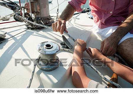 Father and son on board yacht with rope View Large Photo Image Stock Photo - Father and son on board yacht with rope. Fotosearch