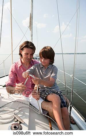 Father and son on board yacht with rope View Large Photo Image Stock Photograph - Father and son on board yacht with rope. Fotosearch