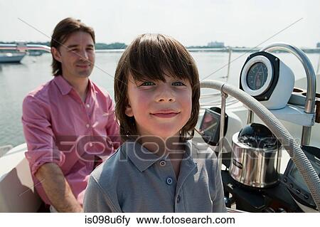 Stock Photo - Father and son sailing yacht. Fotosearch