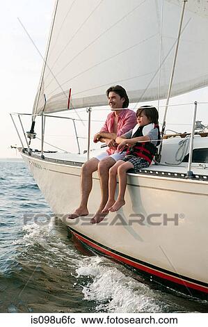 Father and son sitting on yacht View Large Photo Image Stock Image - Father and son sitting on yacht. Fotosearch
