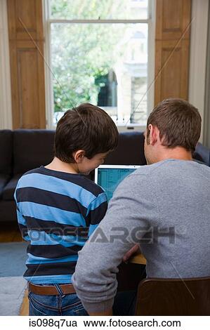 Stock Image - Father and son using a laptop. Fotosearch