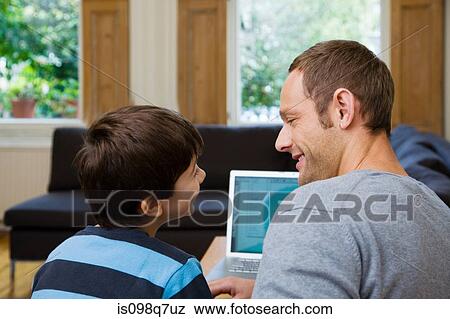 Stock Photo - Father and son using laptop. Fotosearch