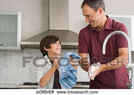 Father and son washing up View Large Photo Image Stock Image - Father and son washing up. Fotosearch