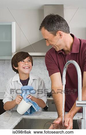 Father and son washing up View Large Photo Image Stock Image - Father and son washing up. Fotosearch