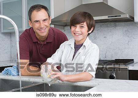 Stock Photograph - Father and son washing up. Fotosearch