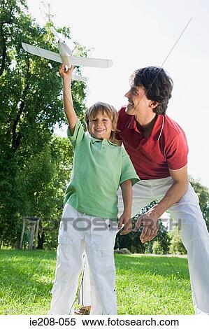 Father and son with toy aeroplane View Large Photo Image Stock Photography - Father and son with toy aeroplane. Fotosearch