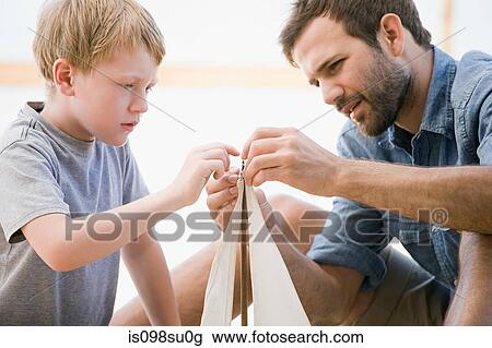 Father and son with toy boat View Large Photo Image Stock Image - Father and son with toy boat. Fotosearch