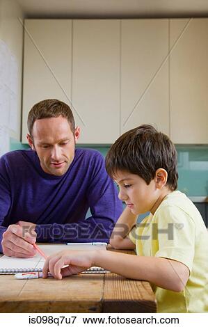 Stock Photo - Father helping his son with his homework. Fotosearch