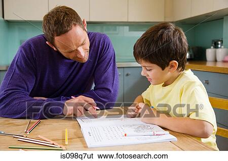 Father helping his son with his homework View Large Photo Image Stock Photograph - Father helping his son with his homework. Fotosearch