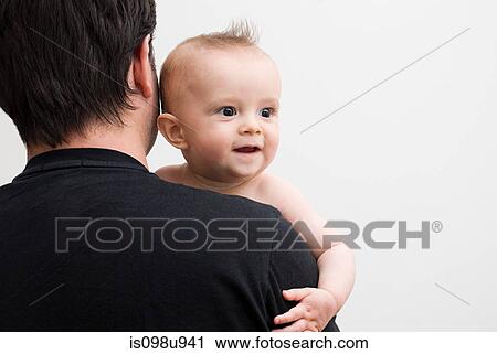 Stock Image - Father holding baby son. Fotosearch