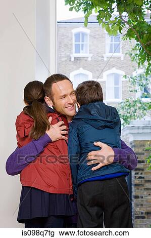 Father hugging son and daughter View Large Photo Image Stock Image - Father hugging son and daughter. Fotosearch