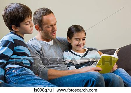 Father reading a book to his children View Large Photo Image Stock Image - Father reading a book to his children. Fotosearch