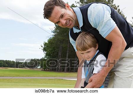 Father teaching his son golf View Large Photo Image Stock Image - Father teaching his son golf. Fotosearch