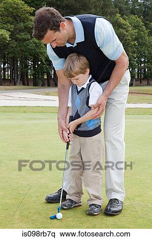 Father teaching his son golf View Large Photo Image Stock Photography - Father teaching his son golf. Fotosearch