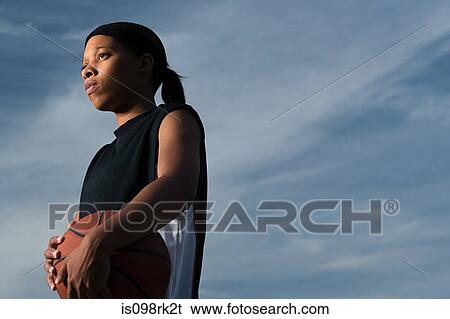 Stock Photograph - Female basketball player. Fotosearch