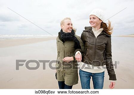 Female friends by the sea View Large Photo Image Stock Photo - Female friends by the sea. Fotosearch