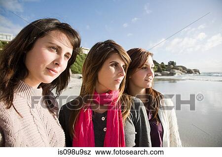 Stock Photo - Female friends looking away. Fotosearch