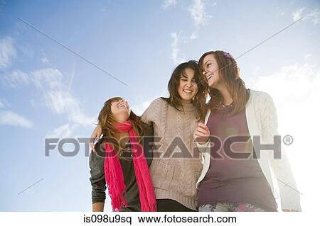 Female friends, low angle view View Large Photo Image Stock Photography - Female friends, low angle view. Fotosearch