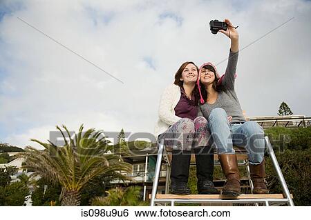 Female friends on lifeguard tower View Large Photo Image Stock Photograph - Female friends on lifeguard tower. Fotosearch