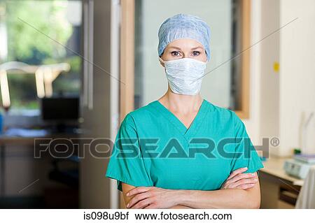 Female surgeon wearing mask View Large Photo Image Stock Image - Female surgeon wearing mask. Fotosearch