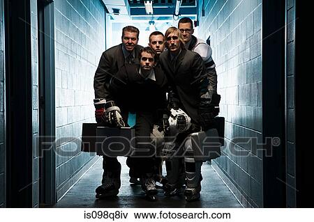 Stock Photo - Five businessmen wearing ice hockey uniforms. Fotosearch