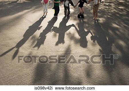 Five children in fancy dress holding hands, casting shadow View Large Photo Image Stock Image - Five children in fancy dress holding hands, casting shadow. Fotosearch