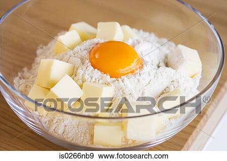 Flour egg and butter in a bowl View Large Photo Image Stock Photo - Flour egg and butter in a bowl. Fotosearch