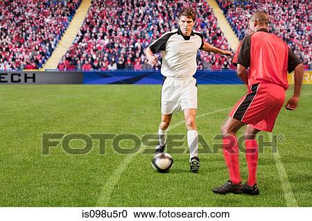 Football players kicking the ball View Large Photo Image Stock Image - Football players kicking the ball. Fotosearch