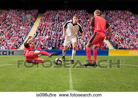 Football players kicking the ball View Large Photo Image Stock Image - Football players kicking the ball. Fotosearch