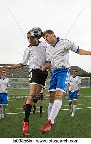 Picture - Footballers heading ball. Fotosearch