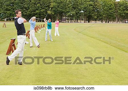 Four golfers on the driving range View Large Photo Image Stock Image - Four golfers on the driving range. Fotosearch