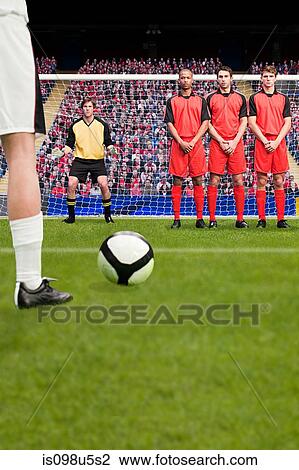Stock Image - Free kick during a football match. Fotosearch