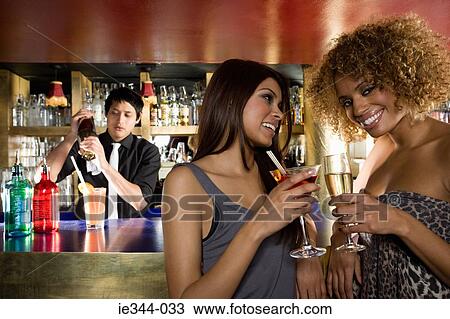 Stock Image - Friends at a bar in a club. Fotosearch