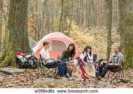 Stock Photo - Friends at campsite. Fotosearch