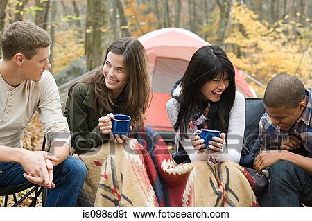 Stock Photograph - Friends at campsite. Fotosearch
