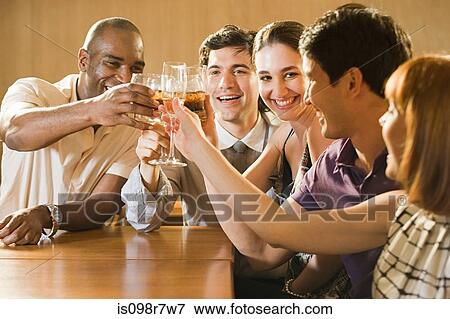 Friends celebrating in a bar View Large Photo Image Stock Photo - Friends celebrating in a bar. Fotosearch