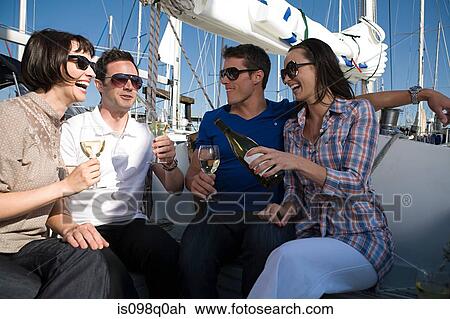 Friends drinking wine on a boat View Large Photo Image Stock Image - Friends drinking wine on a boat. Fotosearch